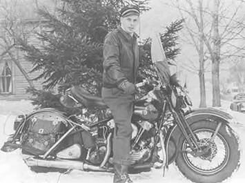 Black and white image of a guy on a motorcycle