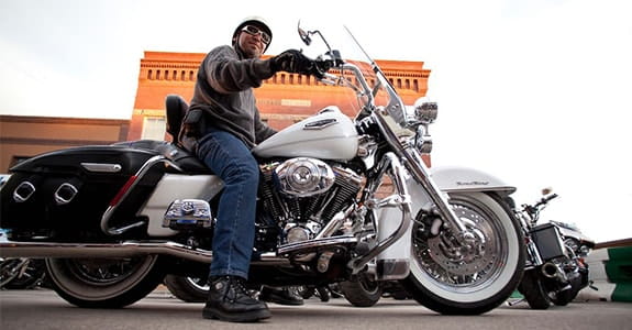 Man sitting on a Harley-Davidson motorcycle