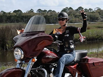 Women riding a Harley Davidson motorcycle