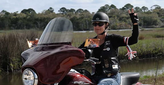 Women riding a Harley Davidson motorcycle
