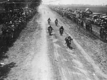 Old black and white image of motorcycles racing