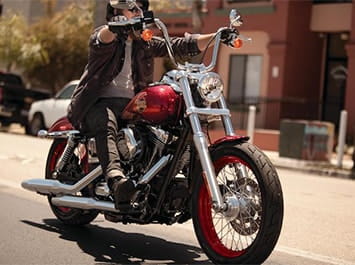 Person riding a red Harley Davidson
