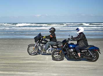 Two Harley-Davidson motorcycles riding on Daytona Beach