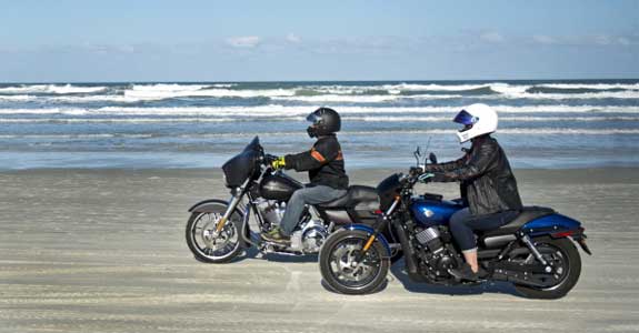 Two Harley-Davidson motorcycles riding on Daytona Beach